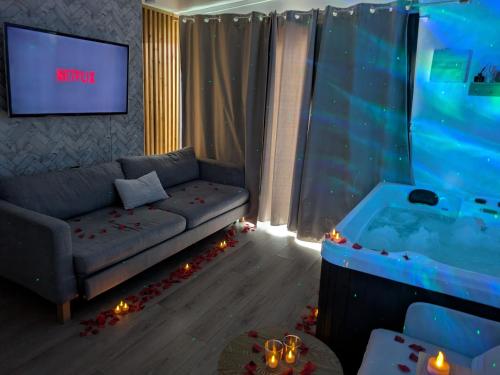 a living room with a couch and a tub at Suite Évasion Spa - Tiny House in Vernouillet