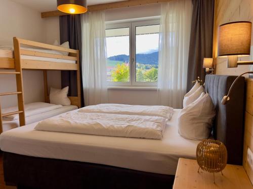 a bedroom with two bunk beds and a window at Winzerchalet in Sankt Lambrecht