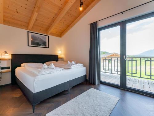 a bedroom with a bed and a large window at Obermöschach 10B in Obermöschach