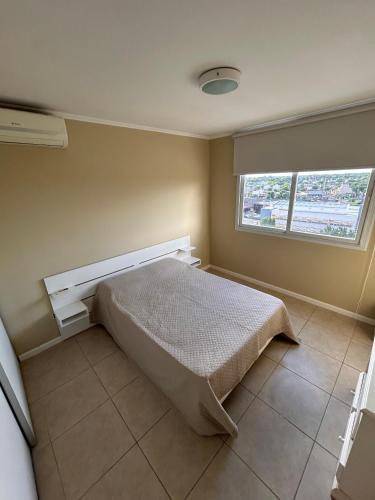 a bedroom with a bed and a window at Portal del Sol in Junín