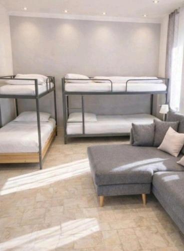 a living room with three bunk beds and a couch at Ferienwohnungen am Holzmarkt, am Rande der Altstadt in Bad Kreuznach