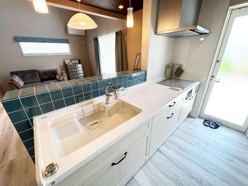 a kitchen with a sink and a couch at i GARDEN in Minami Alps