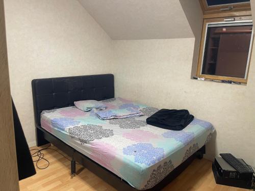 a small bed in a room with a window at Lux 1 in Orléans