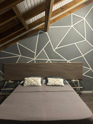 a bedroom with a bed with two pillows on it at Bel Horizon in La Désirade