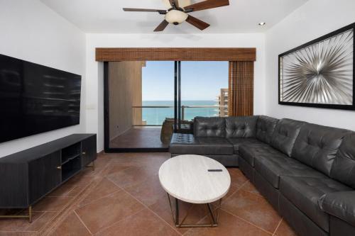 a living room with a couch and a table at Las Palomas F-1402 Oceanfront Premium Condo - Sleeps 4 in Puerto Peñasco