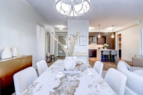 a dining room and kitchen with a table and chairs at Skyline Penthouse in Toronto