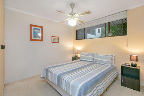 a bedroom with a bed and a ceiling fan at Kirra Gardens Unit 9 in Gold Coast