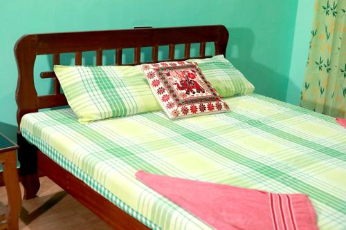 a bed with a pillow sitting on top of it at KK Heritage in Kannur