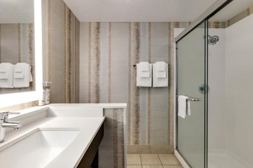 a bathroom with a sink and a shower at Holiday Inn Express Hotel & Suites Eugene Downtown - University by IHG in Eugene