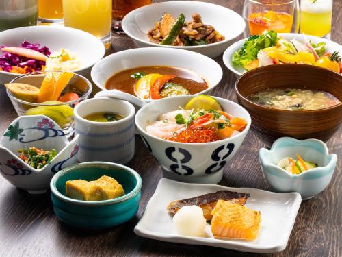 a table topped with bowls of different types of food at Solaria Nishitetsu Hotel Sapporo in Sapporo