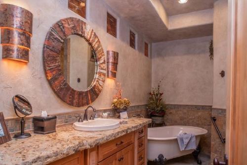 a bathroom with a sink and a tub and a mirror at Cougar Ridge Resort in Torrey