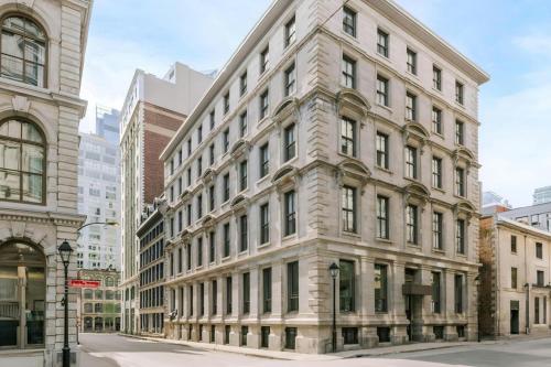 a large stone building on a city street at The Alexander Hotel - Old Montreal in Montréal