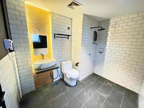 a bathroom with a toilet and a sink at Sky Hotel Cheras Maluri in Kuala Lumpur