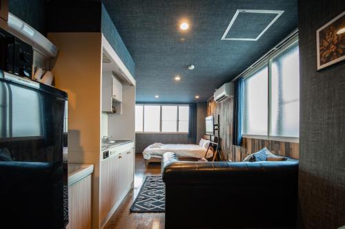 a living room with a couch and a bed in a room at Silk Court 202 in Chitose