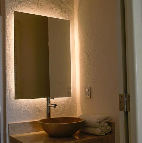 a bathroom with a sink and a large mirror at Hotel Villa Mexicana Puerto Escondido in Puerto Escondido