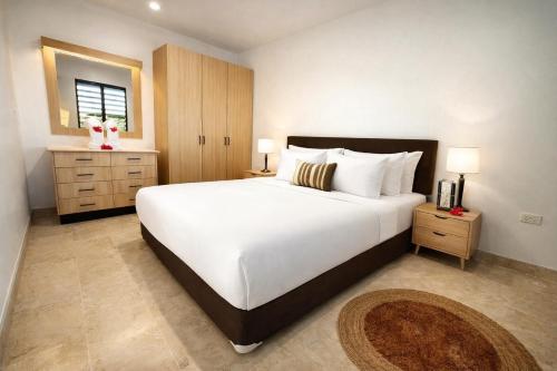 a bedroom with a large white bed and a window at Guest Space Fiji - Port Denarau Apts in Denarau