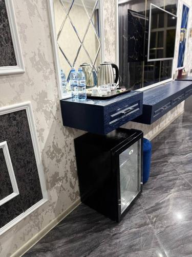 a bathroom with a black vanity and a mirror at Panorama Resort Oghuz in Oğuz