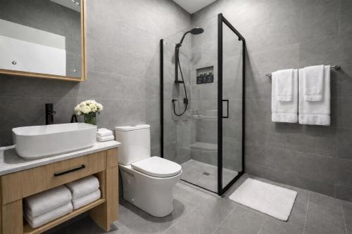 a bathroom with a shower and a toilet and a sink at Guest Space Fiji - Port Denarau Apts in Denarau