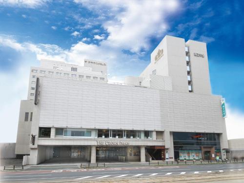 a large white building with a sign on it at ANA Crowne Plaza Kochi by IHG in Sagamichō