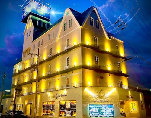 a building with yellow lights on the side of it at かぼちゃの馬車 泉大津大人専用 in Izumiotsu