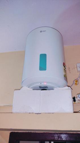 a white appliance sitting on top of a table at SMK homestay in Rāmeswaram