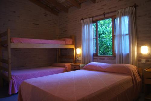 a bedroom with two bunk beds and a window at Lorelei in Mina Clavero