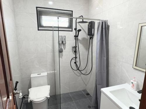 a bathroom with a shower and a toilet and a sink at Lucky home in the heart of thongsala in Thong Sala