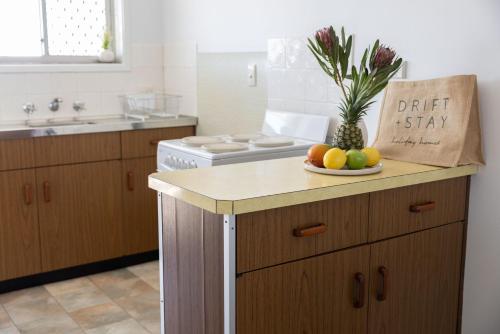 a kitchen with a plate of fruit on a counter at 3-45 Beech Street in Evans Head