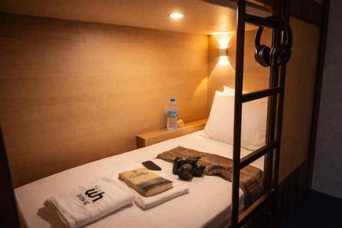 a hotel room with a bed with a camera on it at Wink at Perak Road in Singapore