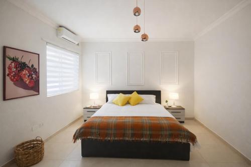 a bedroom with a large bed with two night stands at Stylish 2-Bedroom Apartment in Scenic Marsaxlokk in Marsaxlokk