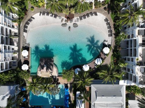an aerial view of a resort pool with palm trees at Peppers Beach Club & Spa in Palm Cove