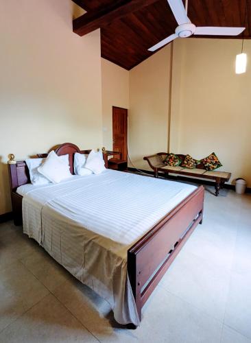 a bedroom with a large bed and a ceiling fan at Hill Crest Mansion in Kandy