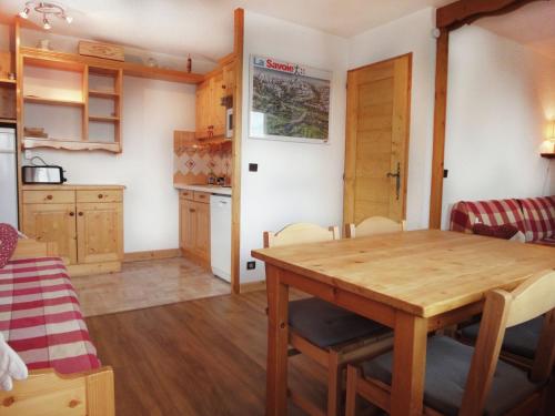 a kitchen and dining room with a wooden table at Spacious flat in M ribel near the ski lifts in Méribel