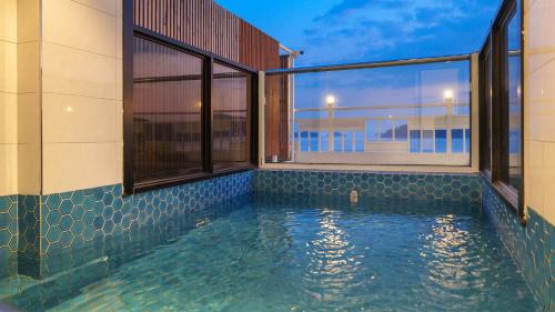 a swimming pool on the side of a building at Yeosu Jangsuri Poolvilla&Spa Pension in Yeosu