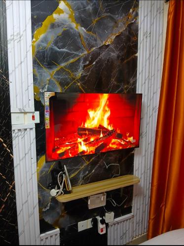 a fireplace in a bathroom with a fire in it at Haven Nest in Machakos