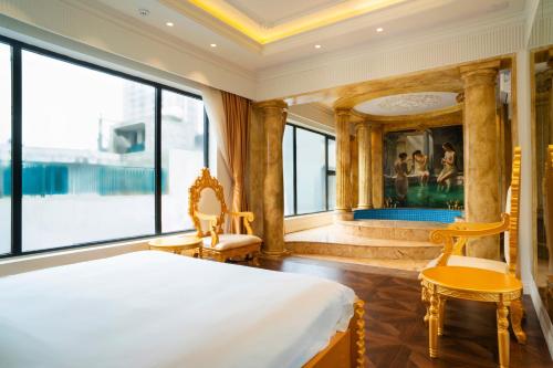 a bedroom with a bed and a large window at Melon Hotel Tố Hữu in Trung Văn