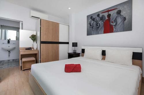 a bedroom with a large white bed and a bathroom at 3 BR Pool Villa Lancelot in Rawai in Ban Saiyuan (1)
