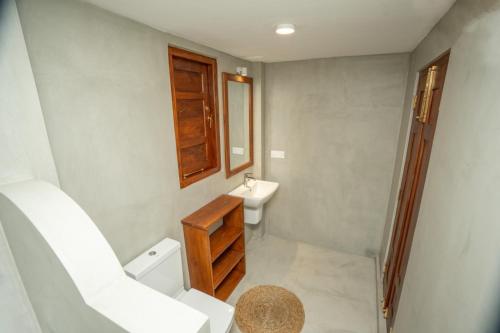 a bathroom with a sink and a toilet and a mirror at Villa Paranawatta in Unawatuna