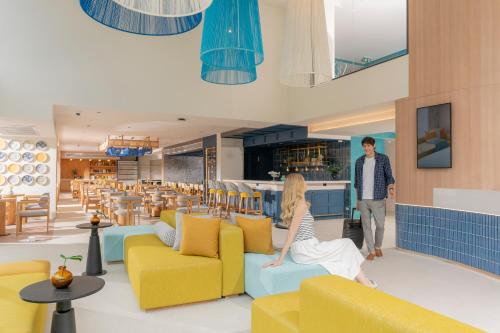 a rendering of a restaurant with yellow and blue furniture at ibis Styles Phuket Bangtao in Bang Tao Beach