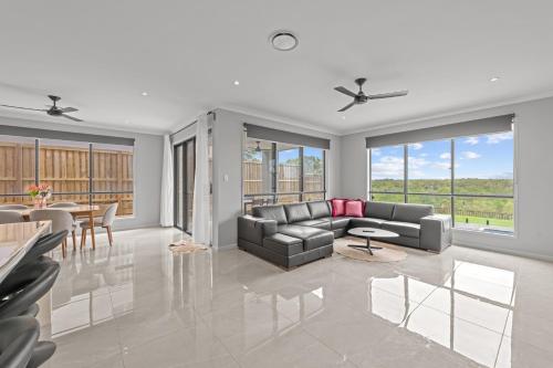 a living room with a couch and a table at Spacious 4 Bed Home with Pool & Garden in Griffin