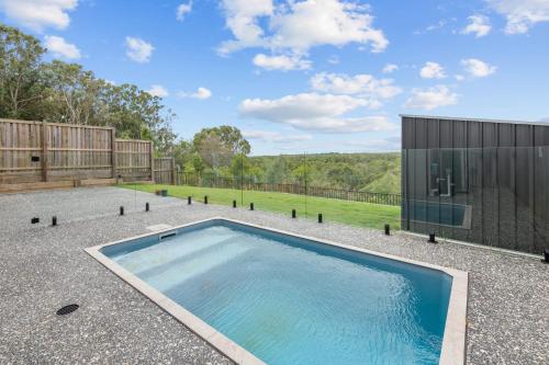 a swimming pool in the backyard of a house at Spacious 4 Bed Home with Pool & Garden in Griffin