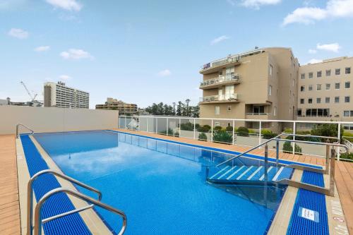 a large swimming pool on the roof of a building at Spacious 1 Bed Near Manly Beach in Sydney