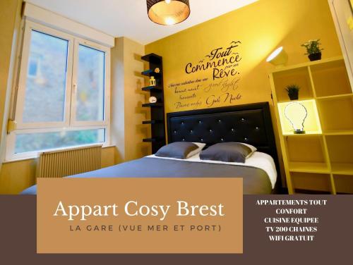 a bedroom with a bed with a sign on the wall at Appart Cosy Brest (La gare) vue mer in Brest