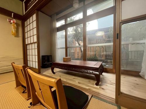 a room with a table and chairs and a large window at komorebi - Vacation STAY 19085 in Hakodate