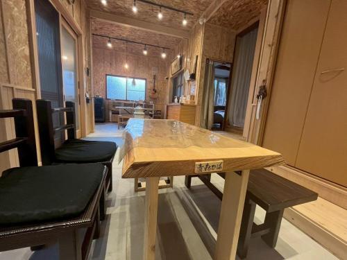 a dining room with a wooden table and benches at komorebi - Vacation STAY 19085 in Hakodate