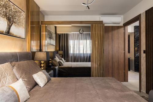 a bedroom with a large bed in a room at Blazer suite on the sea in Neoi Epivates
