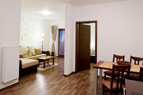 a living room with a couch and a table at Apartmán Chopok juh Monika in Tale