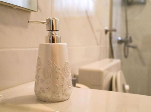 a soap dispenser sitting on a sink in a bathroom at Franov Butique Residence in Kali