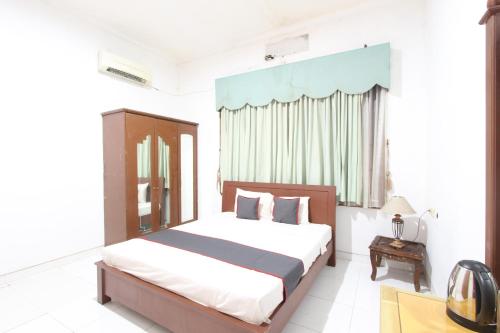 a bedroom with a large bed and a window at Bimo Inn Malioboro in Yogyakarta