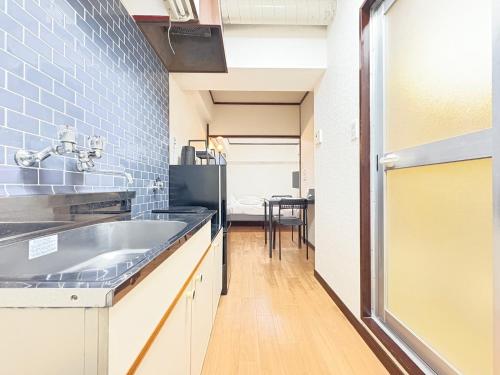 a kitchen with a sink and a table at ウィングランデ博多南 in Fukuoka
